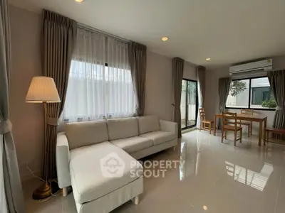 Spacious modern living room with large windows and elegant furniture
