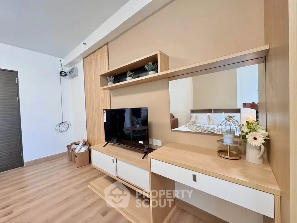 Modern living room with stylish wooden furniture and TV setup, perfect for cozy relaxation.