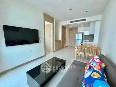 Modern living room with sleek furniture and open kitchen layout in a stylish apartment.