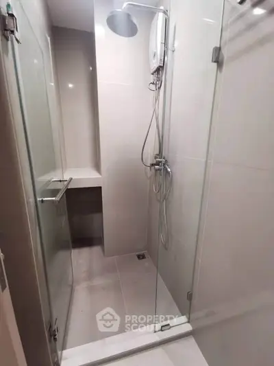 Modern bathroom with glass shower enclosure and sleek fixtures