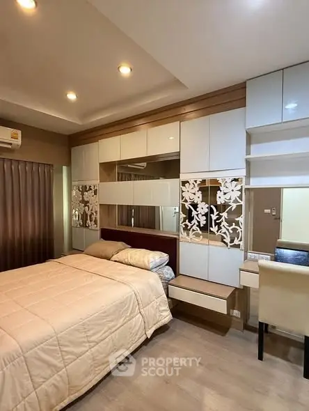 Modern bedroom with stylish decor and ample storage space