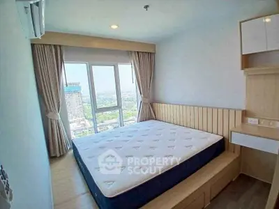 Modern bedroom with large window offering stunning city view, featuring a comfortable bed and sleek wooden furnishings.