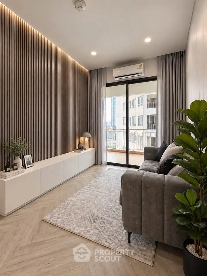 Modern living room with stylish decor and large balcony access, featuring elegant lighting and cozy seating.