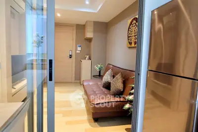 Modern living room with sleek design and stainless steel fridge