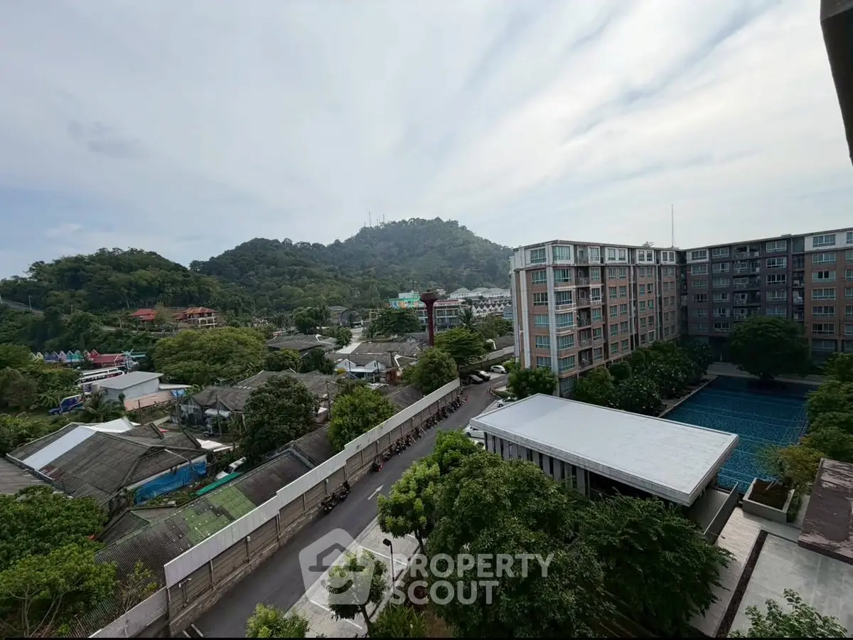 Scenic view of residential complex with lush greenery and mountain backdrop