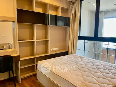 Modern bedroom with built-in shelving and large window for natural light