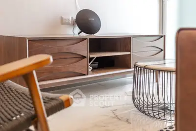 Stylish modern living room with elegant wooden furniture and sleek marble flooring.