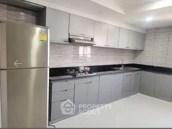 Modern kitchen with sleek cabinetry and stainless steel appliances in a contemporary home.