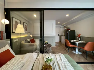 Modern studio apartment with cozy living area and stylish dining space