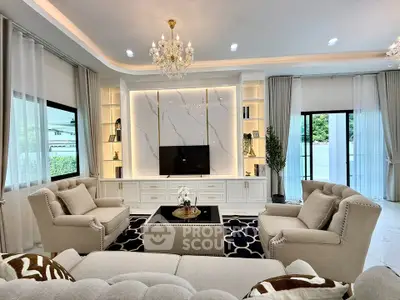 Luxurious living room with elegant chandelier and plush seating