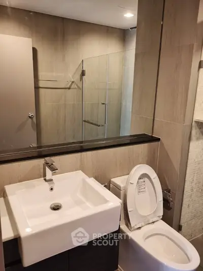 Modern bathroom with sleek fixtures and glass shower enclosure