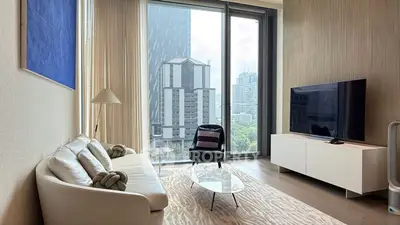 Modern living room with large windows and city view, featuring stylish furniture and contemporary decor.