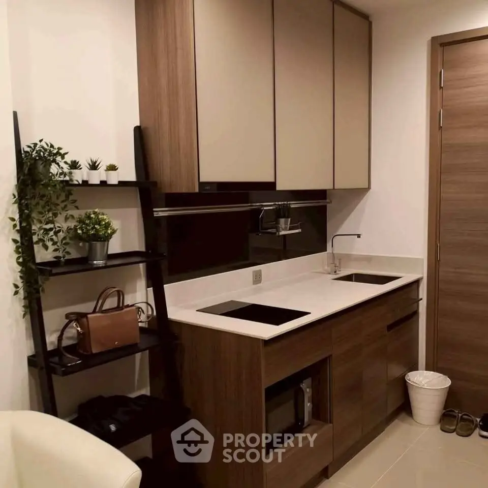 Modern kitchen with sleek cabinetry and dual cooktop in a stylish apartment.