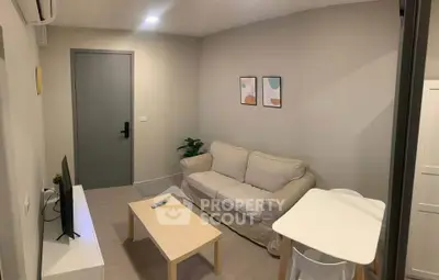 Cozy living room with modern decor and comfortable seating in a stylish apartment.