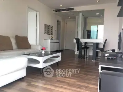 Modern living room with sleek furniture and open layout, featuring hardwood floors and stylish decor.