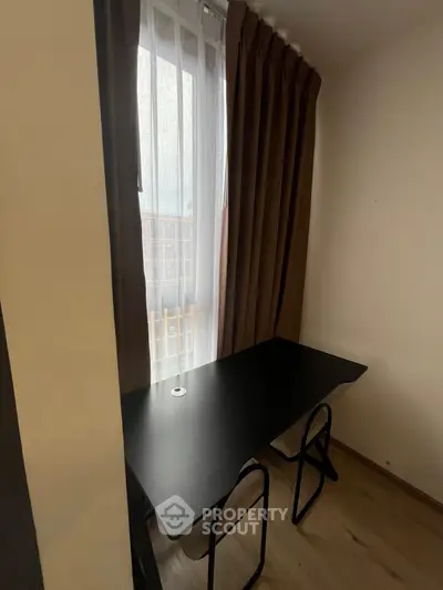 Cozy study nook with desk and chair by window, perfect for productivity.