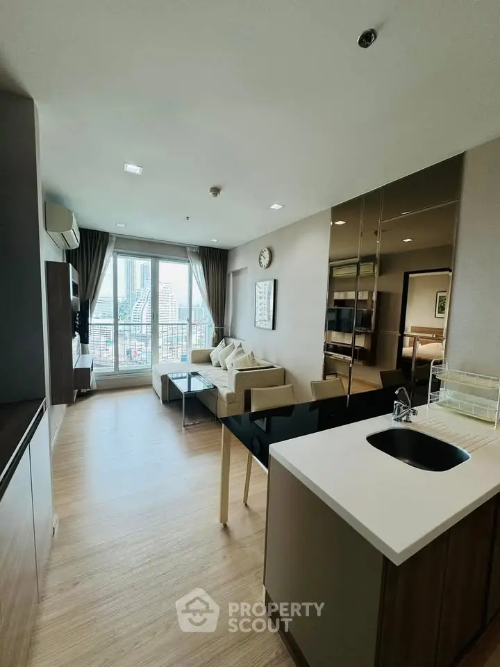 Modern living room with city view, open layout, and stylish furnishings.