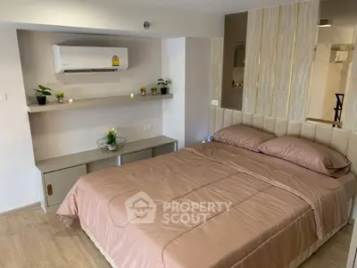 Cozy bedroom with modern decor and air conditioning, perfect for relaxation.