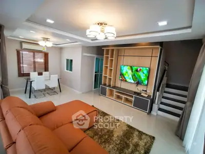 Modern living room with stylish furniture and entertainment center, perfect for family gatherings.