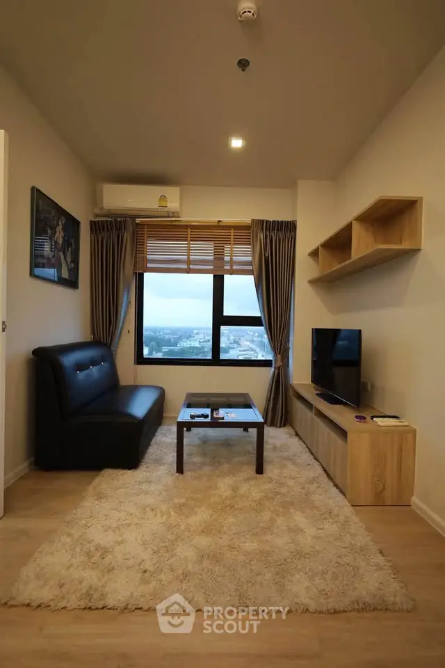 Modern living room with city view, cozy sofa, and stylish decor