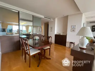 Elegant dining area with wooden flooring and stylish furniture in a modern apartment