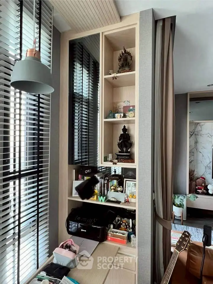 Modern study area with built-in shelves and stylish decor in a contemporary apartment.