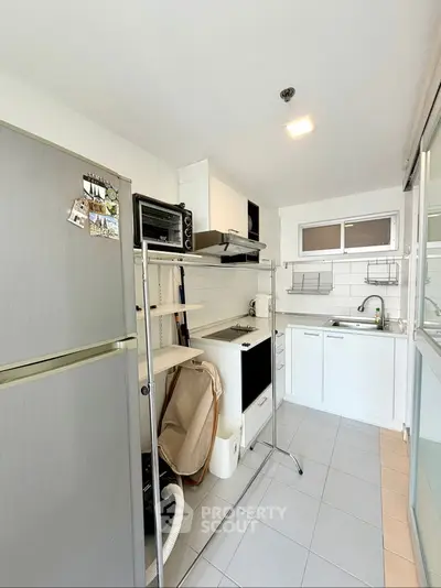 Modern kitchen with sleek white cabinets and contemporary appliances