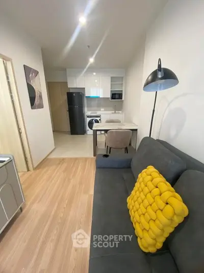 Modern apartment interior with cozy living area and compact kitchen