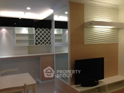 Modern living room with built-in shelves and TV unit