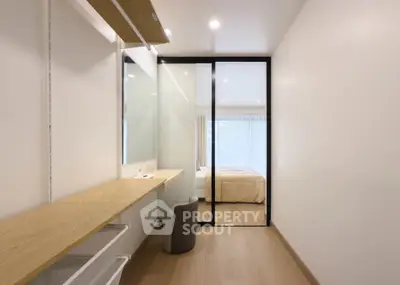 Modern minimalist bedroom with sliding glass door and wooden accents