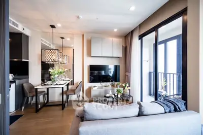 Elegant modern living room seamlessly connected to a well-equipped kitchen, featuring stylish furnishings, ample natural light, and a cozy balcony with a view.