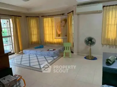 Spacious bedroom with large windows and air conditioning, featuring a minimalist setup.