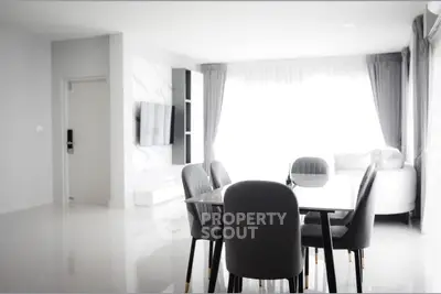 Modern living room with sleek dining area and stylish decor
