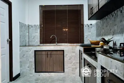 Modern kitchen with sleek cabinetry and tiled backsplash