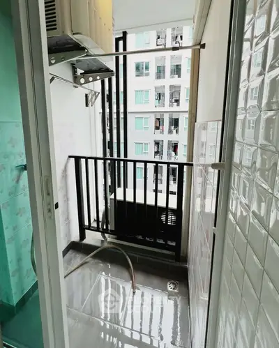 Compact balcony with city view and laundry area in modern apartment