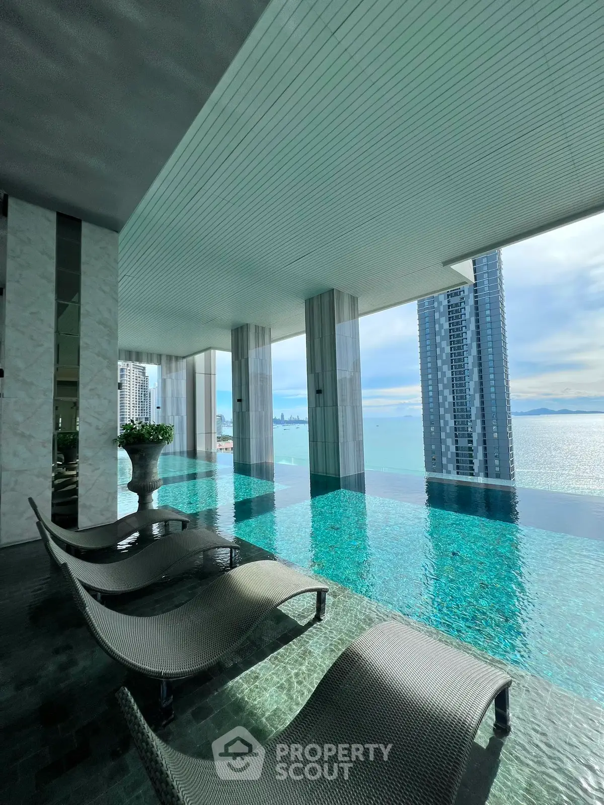 Luxurious rooftop infinity pool with stunning ocean and city skyline views.