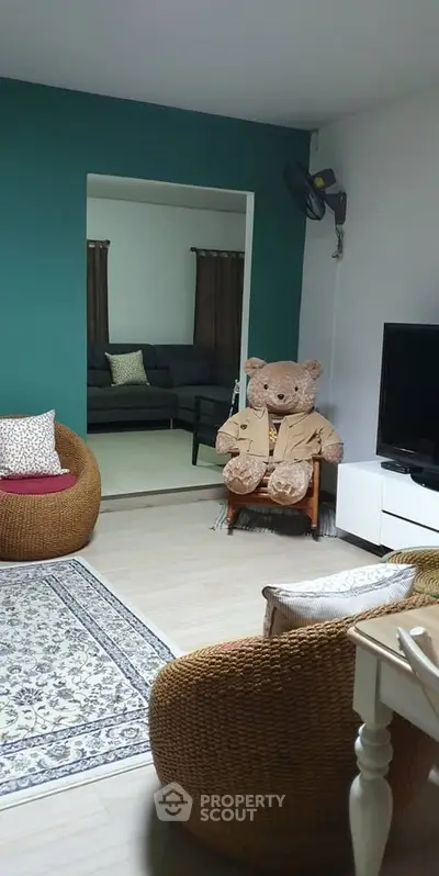 Cozy living room with stylish furniture and large teddy bear decor