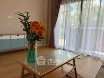 Charming living room with elegant decor and large windows for natural light.