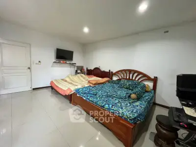Spacious bedroom with two beds and modern amenities, perfect for comfort and relaxation.