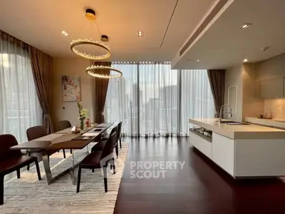 Luxurious open-plan dining and kitchen area with elegant lighting and city view.