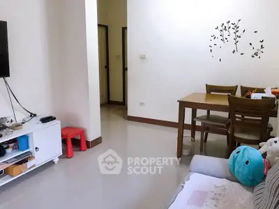 Cozy living room with modern decor and dining area, perfect for relaxation and entertaining guests.