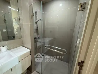 Modern bathroom with glass shower and sleek fixtures