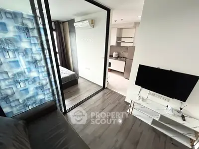 Modern apartment interior with open layout, featuring a cozy living area, sleek kitchen, and stylish bedroom.