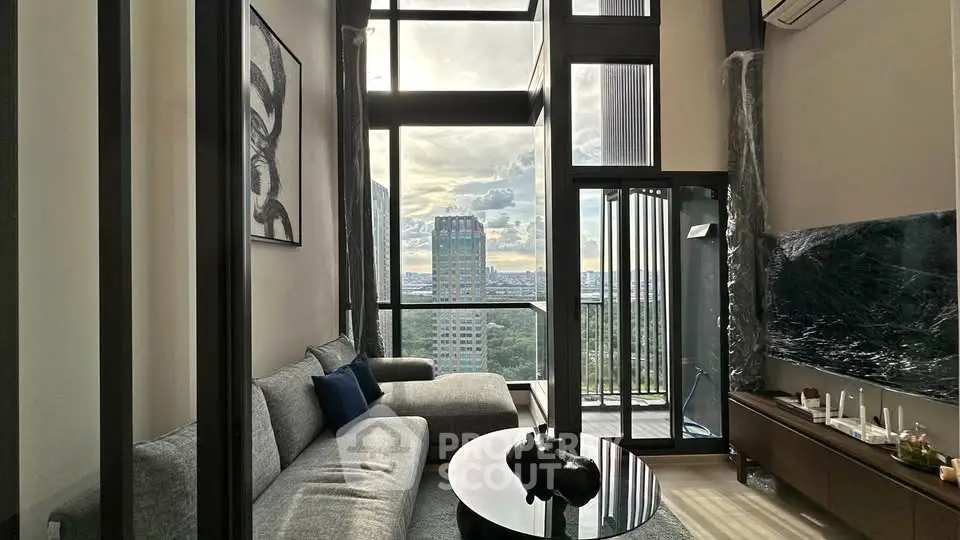 Luxurious high-rise living room with floor-to-ceiling windows and stunning city view.