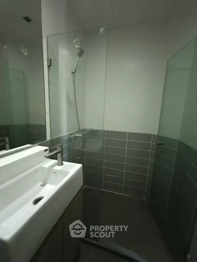 Modern bathroom with glass shower and sleek sink design