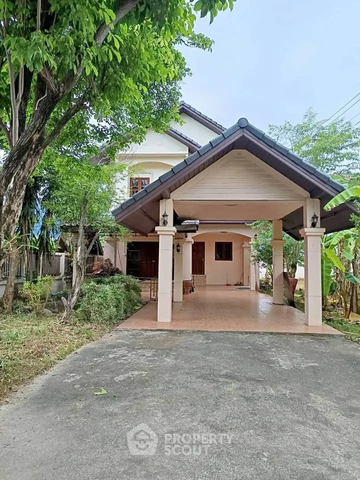 Charming two-story house with spacious driveway and lush greenery