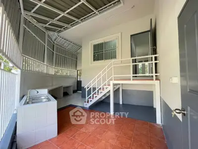 Spacious modern kitchen with open layout and sleek design, featuring tiled flooring and ample natural light.
