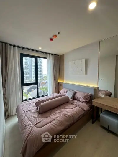 Modern bedroom with large window and stylish decor in urban apartment