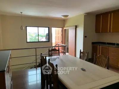 Spacious dining area with natural light and modern kitchen in open layout
