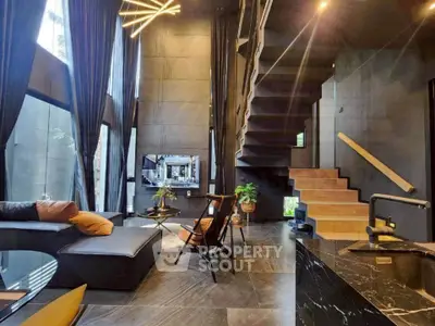 Luxurious modern living room with high ceilings and stylish staircase